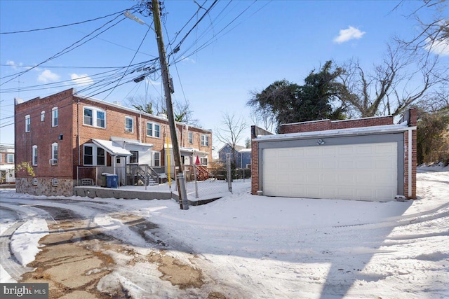 exterior space with a garage and an outbuilding