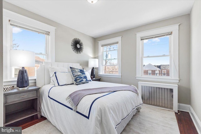 bedroom featuring radiator and wood-type flooring