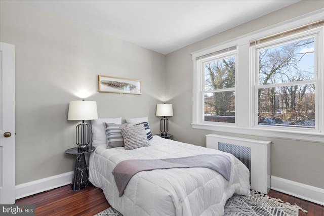 bedroom featuring dark hardwood / wood-style flooring and radiator