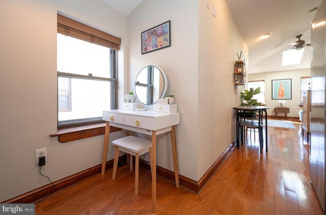 hallway featuring a wealth of natural light and hardwood / wood-style flooring