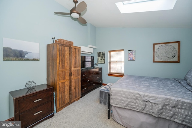 carpeted bedroom with an AC wall unit, ceiling fan, and vaulted ceiling with skylight