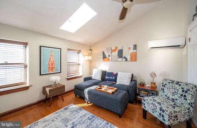 living room with a wall mounted AC, ceiling fan, lofted ceiling with skylight, and hardwood / wood-style flooring