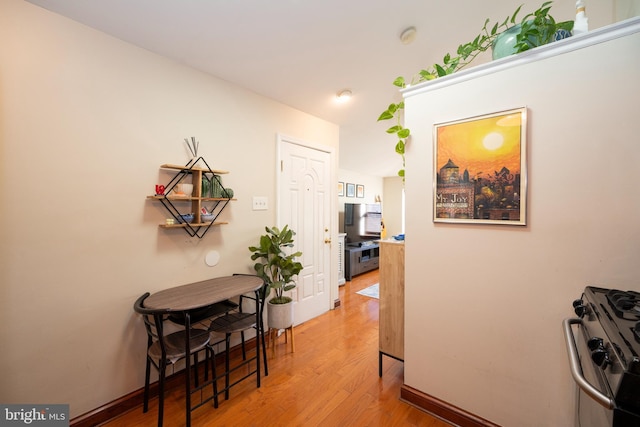 hall with hardwood / wood-style floors