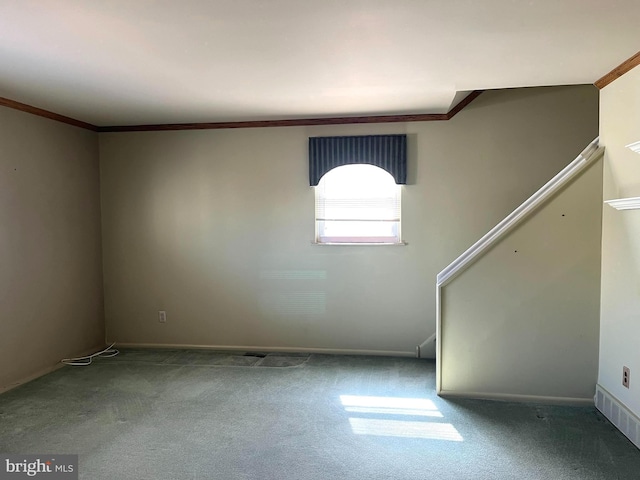 empty room with crown molding, stairway, carpet flooring, and baseboards