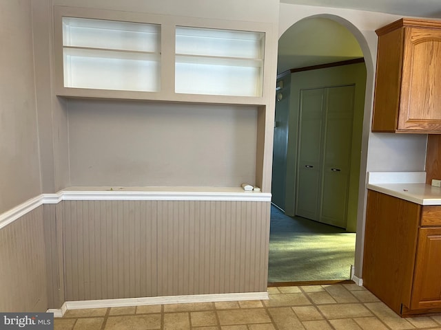 interior space with brown cabinetry and light countertops