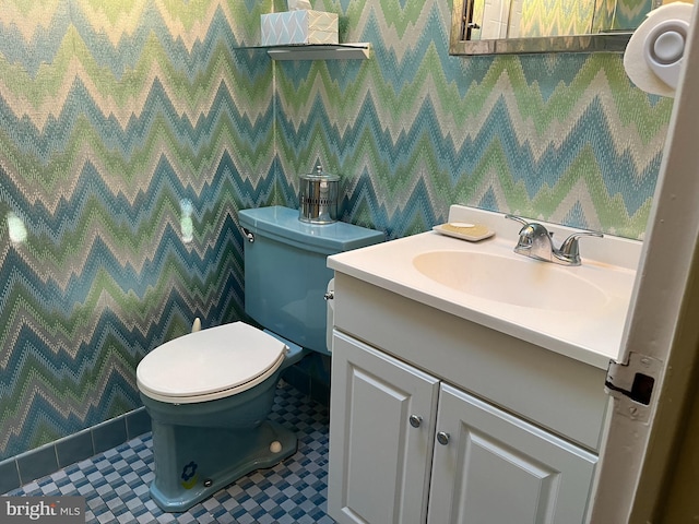 bathroom featuring vanity, toilet, tile patterned flooring, and wallpapered walls