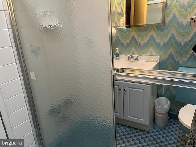 full bathroom with toilet, a stall shower, and vanity