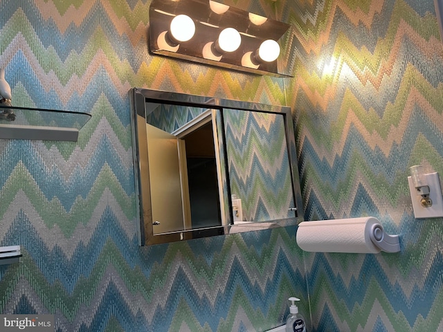 bathroom featuring wallpapered walls