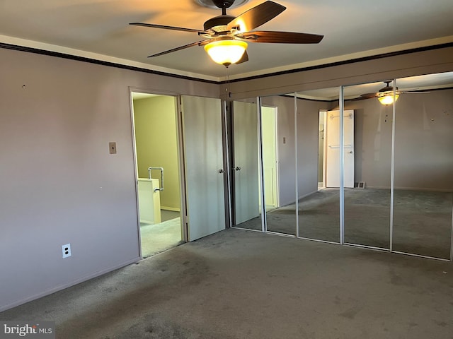 unfurnished bedroom featuring carpet flooring and ceiling fan