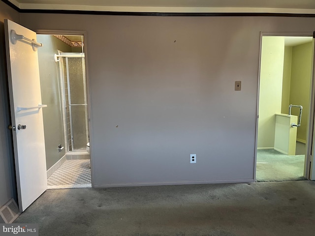 unfurnished room featuring visible vents, carpet floors, and baseboards