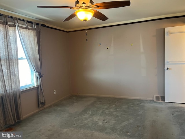 carpeted empty room with visible vents, crown molding, and baseboards