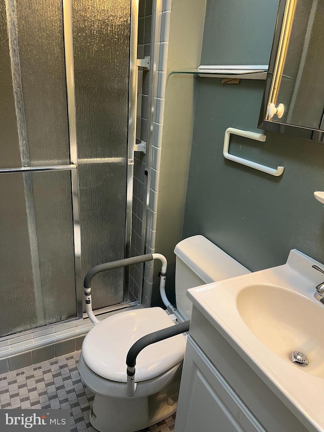 full bath featuring vanity, toilet, and a shower stall