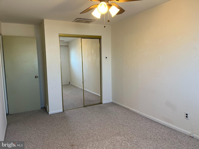 unfurnished bedroom with a closet, carpet flooring, baseboards, and visible vents