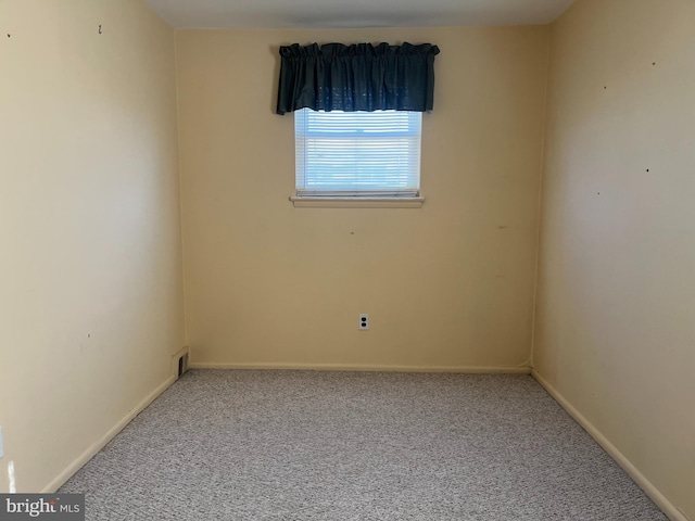 empty room with carpet flooring and baseboards