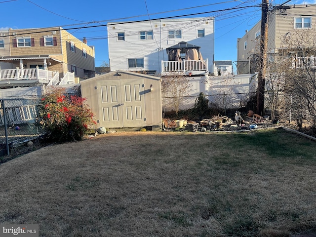 exterior space featuring an outbuilding, a storage unit, and a fenced backyard