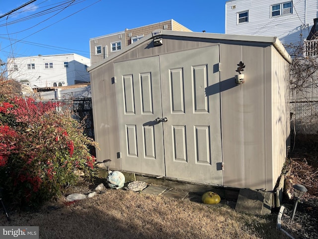 view of shed with fence