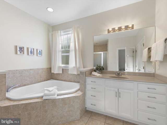 bathroom featuring tile patterned flooring, vanity, and independent shower and bath