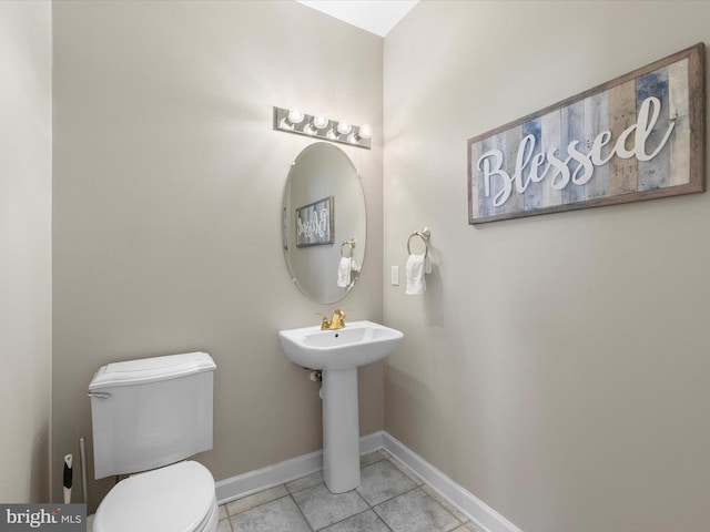 bathroom with tile patterned floors, sink, and toilet