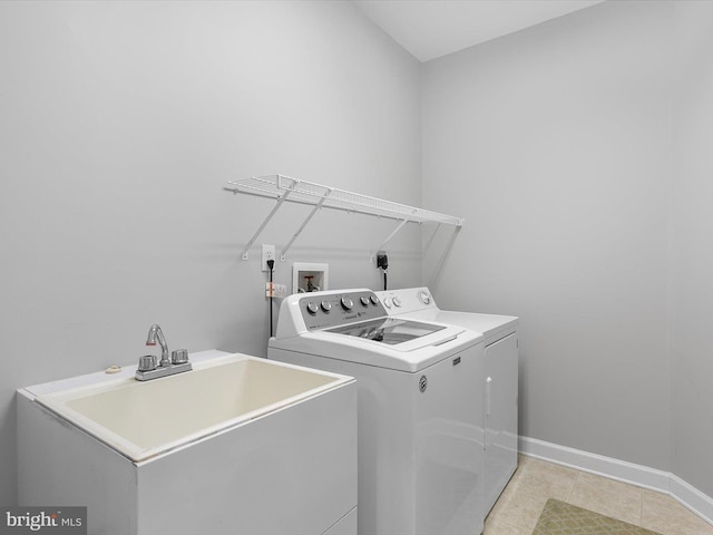 laundry room with washing machine and dryer, sink, and light tile patterned flooring