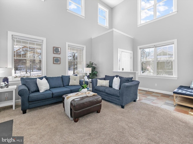 tiled living room with a healthy amount of sunlight and a high ceiling