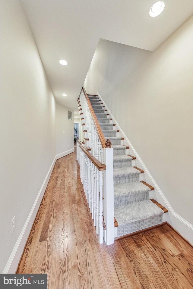 staircase featuring wood-type flooring