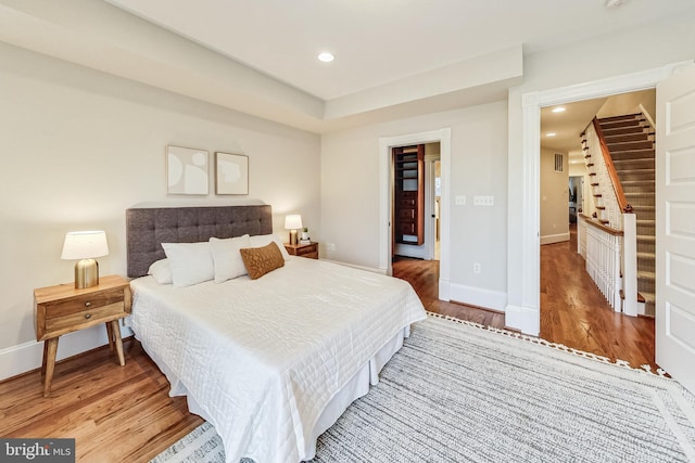 bedroom with hardwood / wood-style flooring