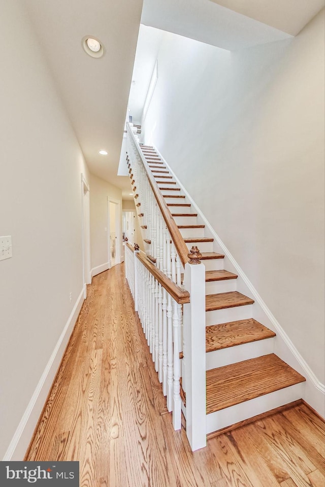 stairway with hardwood / wood-style floors