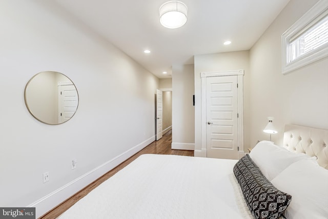 bedroom with dark hardwood / wood-style floors