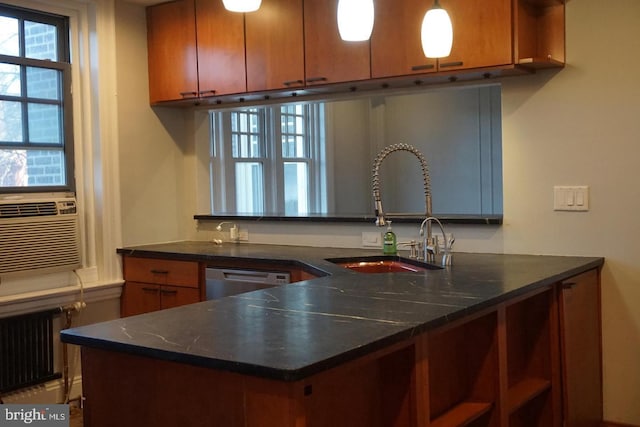 kitchen featuring stainless steel dishwasher, radiator, cooling unit, sink, and hanging light fixtures