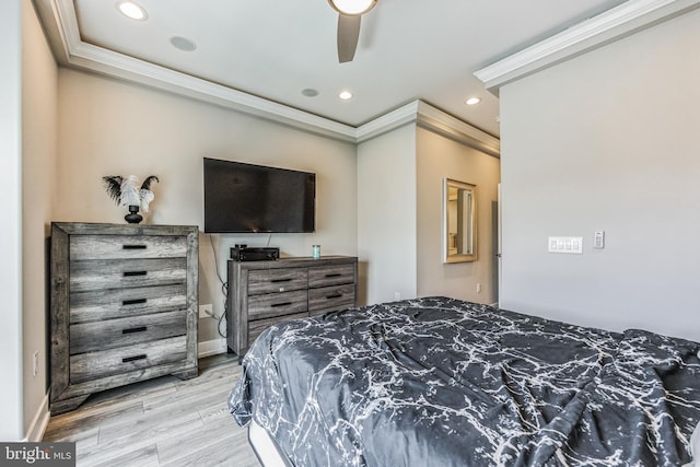 bedroom with light hardwood / wood-style flooring, ceiling fan, and ornamental molding