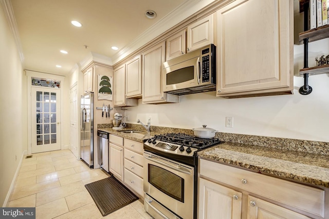 kitchen with light stone countertops, sink, crown molding, light tile patterned floors, and appliances with stainless steel finishes