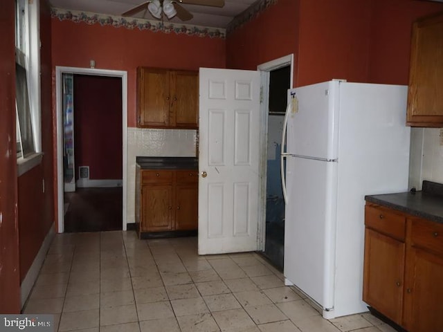 kitchen with ceiling fan and white fridge