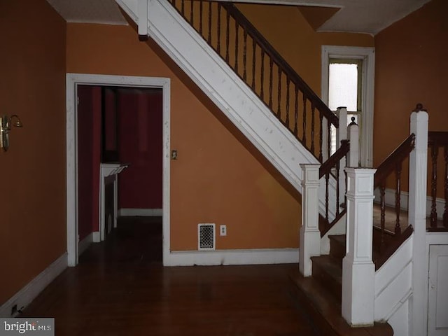 stairway featuring hardwood / wood-style flooring