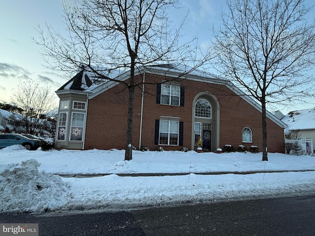 view of front of house with a garage and brick siding