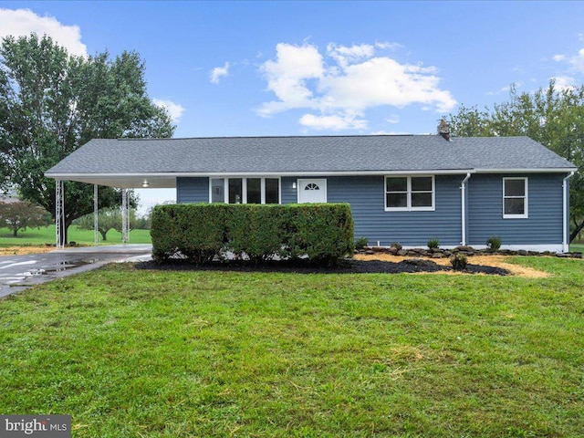 single story home featuring a front lawn and a carport