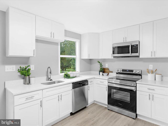 kitchen featuring white cabinets, stainless steel appliances, and sink