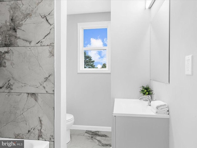 bathroom featuring a shower, vanity, and toilet