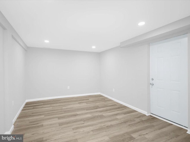 basement with light hardwood / wood-style flooring