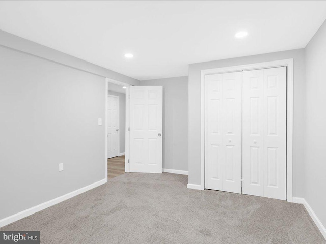 unfurnished bedroom with carpet flooring and a closet