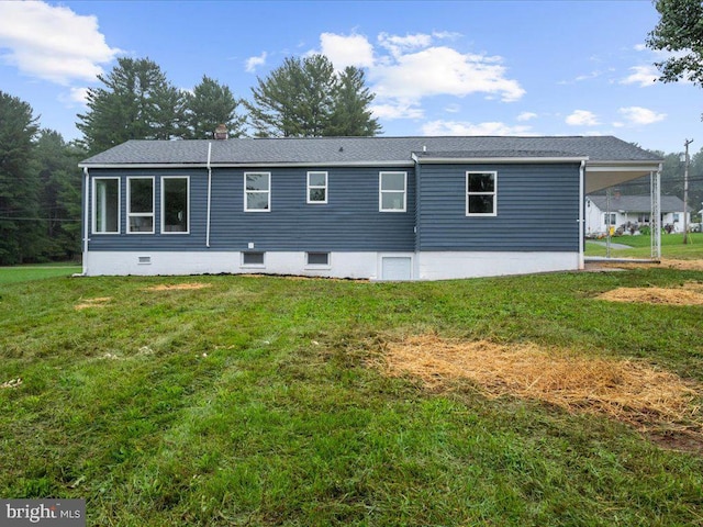 rear view of house featuring a lawn