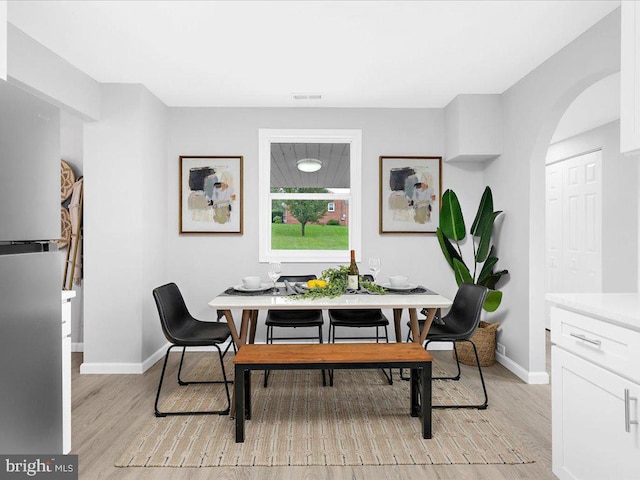 dining space with light hardwood / wood-style flooring