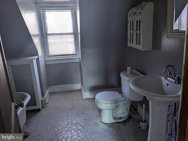 bathroom featuring radiator heating unit, tile patterned flooring, and toilet