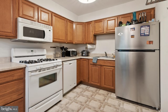 kitchen featuring sink and white appliances