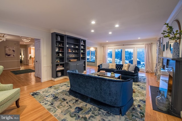 living room featuring crown molding and light hardwood / wood-style floors