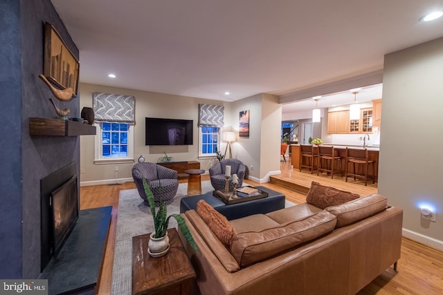 living room with sink and light hardwood / wood-style flooring