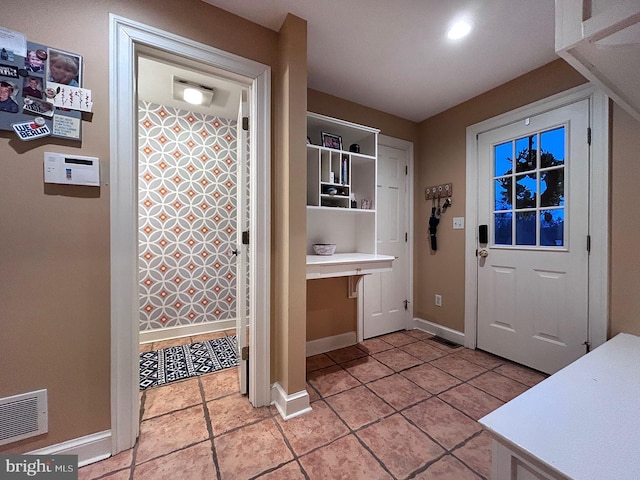 doorway with light tile patterned flooring