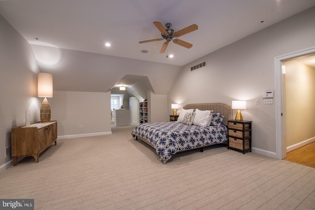 carpeted bedroom with ceiling fan and vaulted ceiling