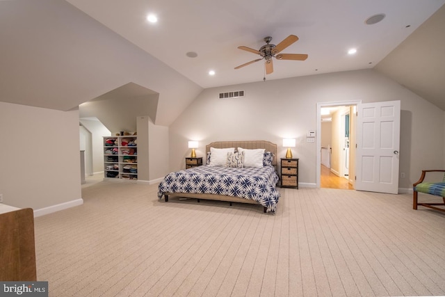 bedroom with ceiling fan, light colored carpet, and lofted ceiling