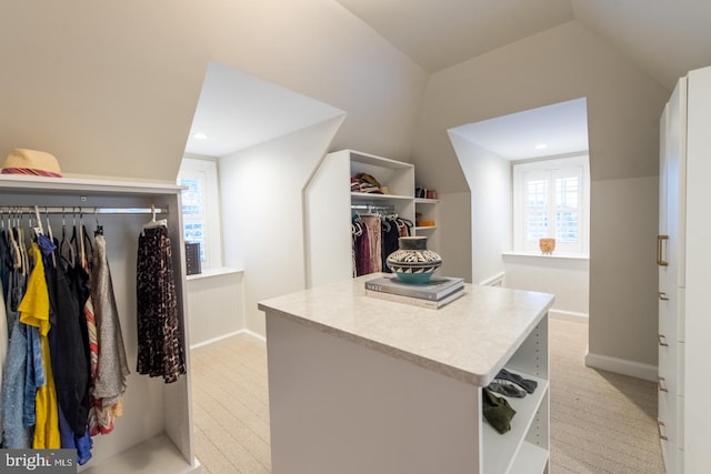 walk in closet with vaulted ceiling