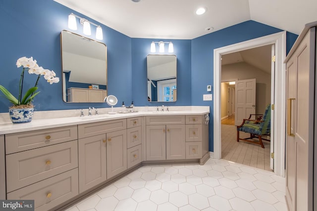 bathroom with vanity and vaulted ceiling